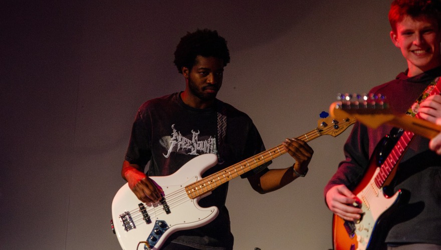 2 guys playing guitar 