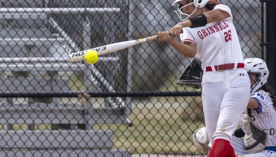 A batter in mid swing at home plate.