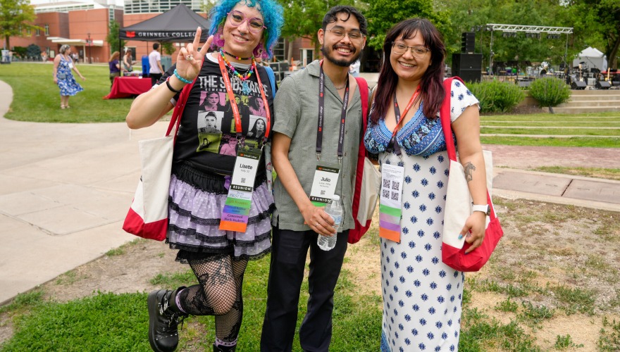 Three alums pose for a photo at Block Party.