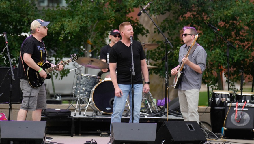 An alumni band performers on an outdoor stage during Block Party.