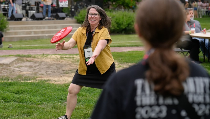 An alum catches a frisbee during Block Party.