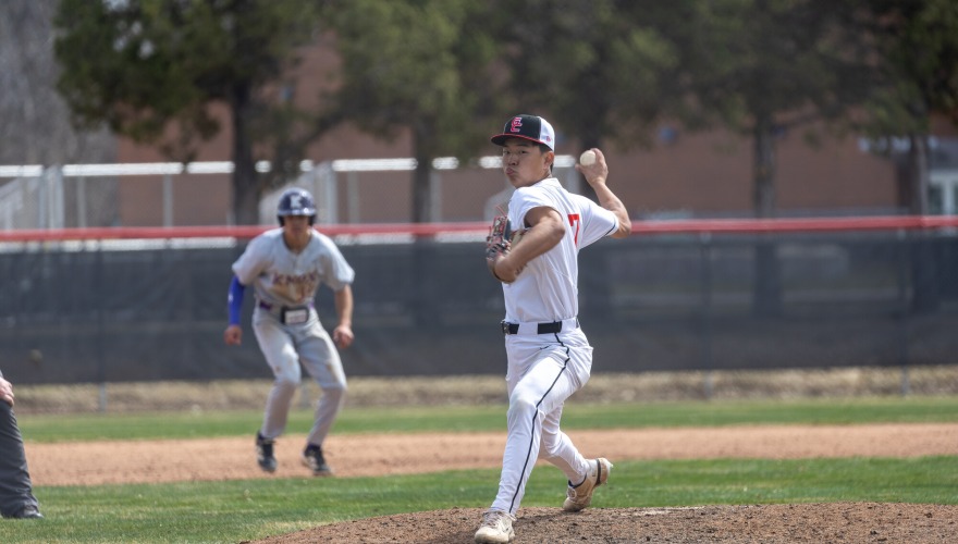 Pitcher winds up to throw the ball during the game.