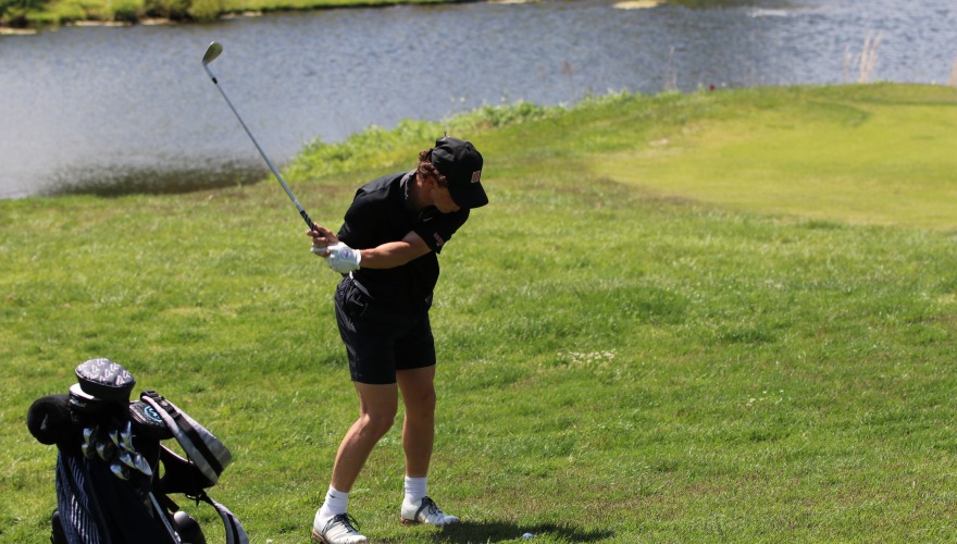 A golfer in the middle of a backswing.