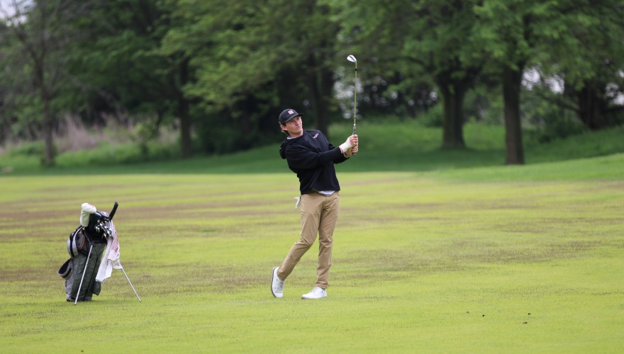Golfer looks on after completing their drive.