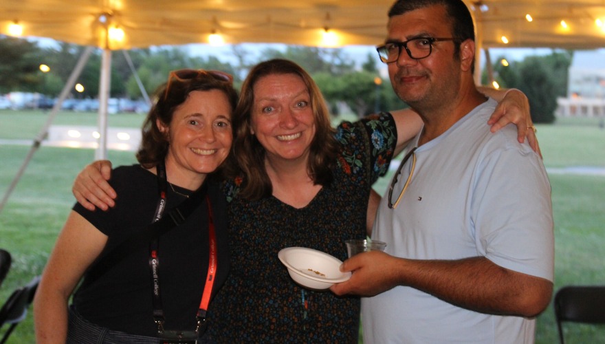 Three alums pose for a photo during a class year welcome party.