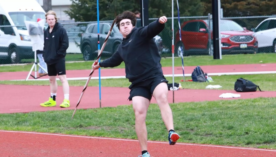 A javelin thrower winds up during an outdoor event. 
