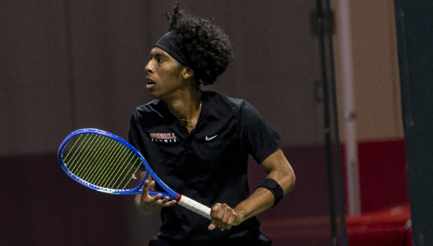 Men’s tennis player in a ready position waiting to receive the serve.