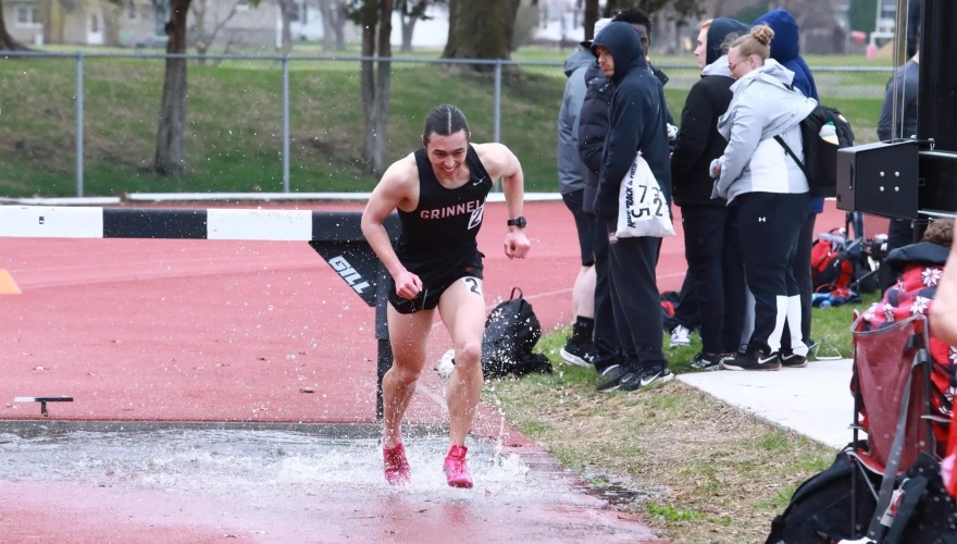 Track athlete running at an outdoor meet.