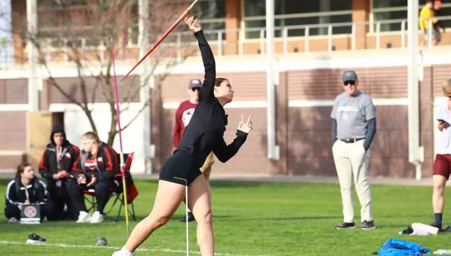 A thrower winds up during a meet.
