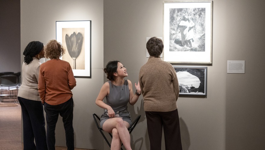 4 women looking at art in museum