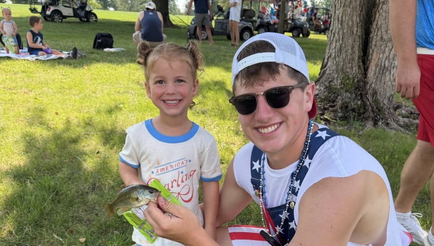 little girl and a guy with fish