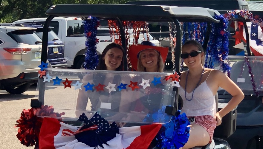 people in a decorated golf cart