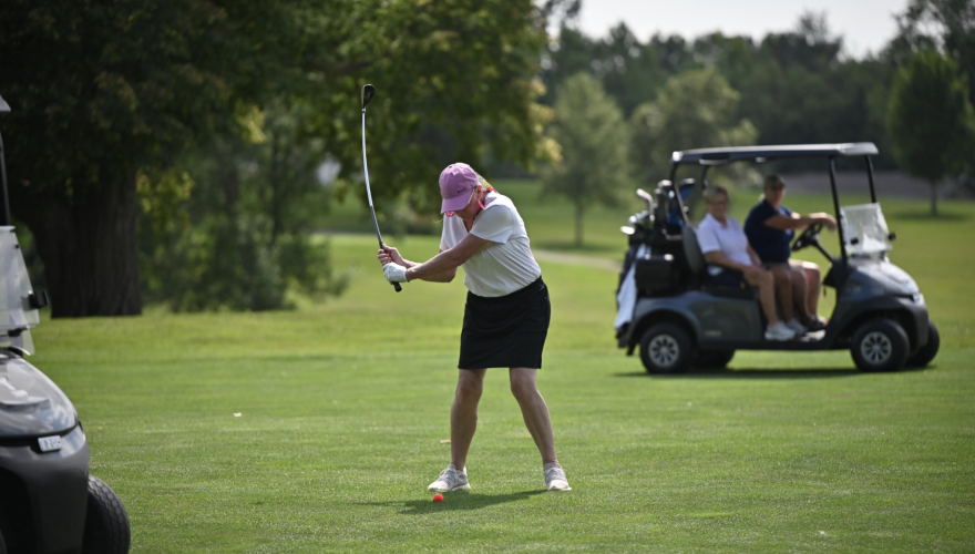 woman hitting golf ball