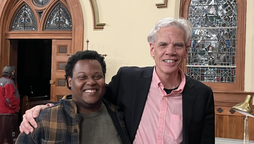 Director John Rommereim stands with Errol in a church.