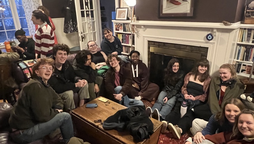 Group of Singers sitting closely together in a living room.