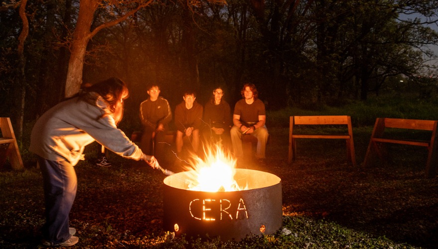 Students having a bonfire at night