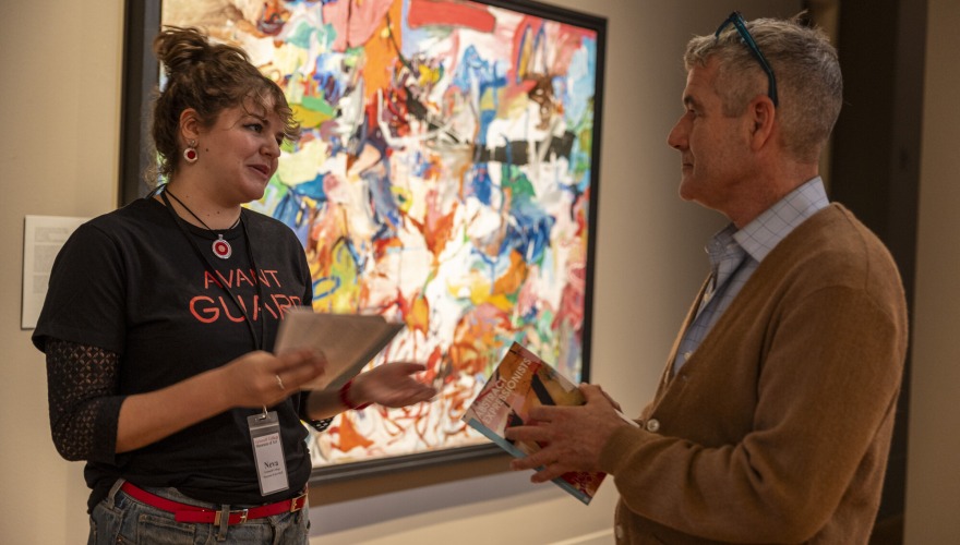 David Harrison and another person talking in gallery
