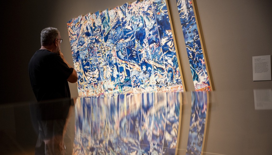 Jim Powers looking at art that is blue