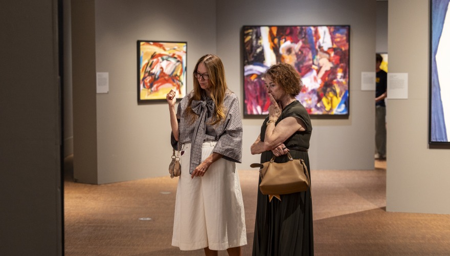 2 people looking at art