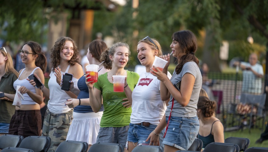 A group of students laugh and sing a long during the concert.