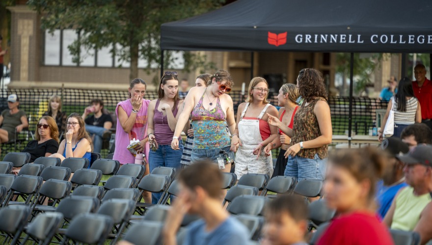 A group of students stand and sing a long at the concert.