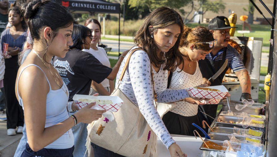 Students serve themselves food outside