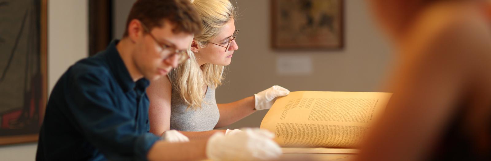 Students looking at documents in the archives