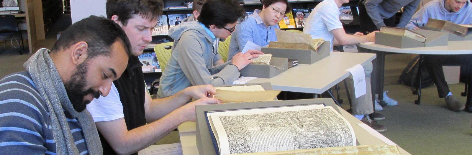 Students in the History of Technology class examine early modern books from Special Collections