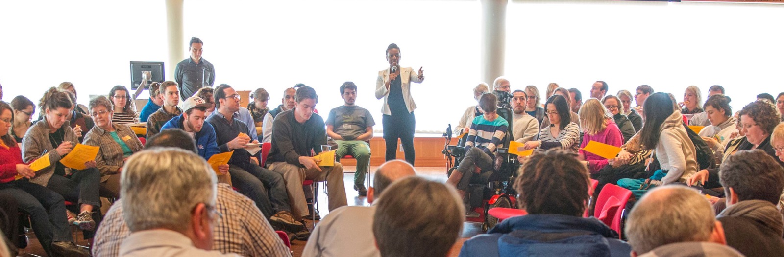 Student leads a town hall meeting in Rosenfield Center, Room 101