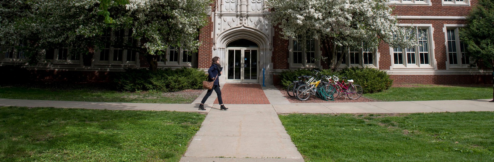 Student walking in front of ARH in spring