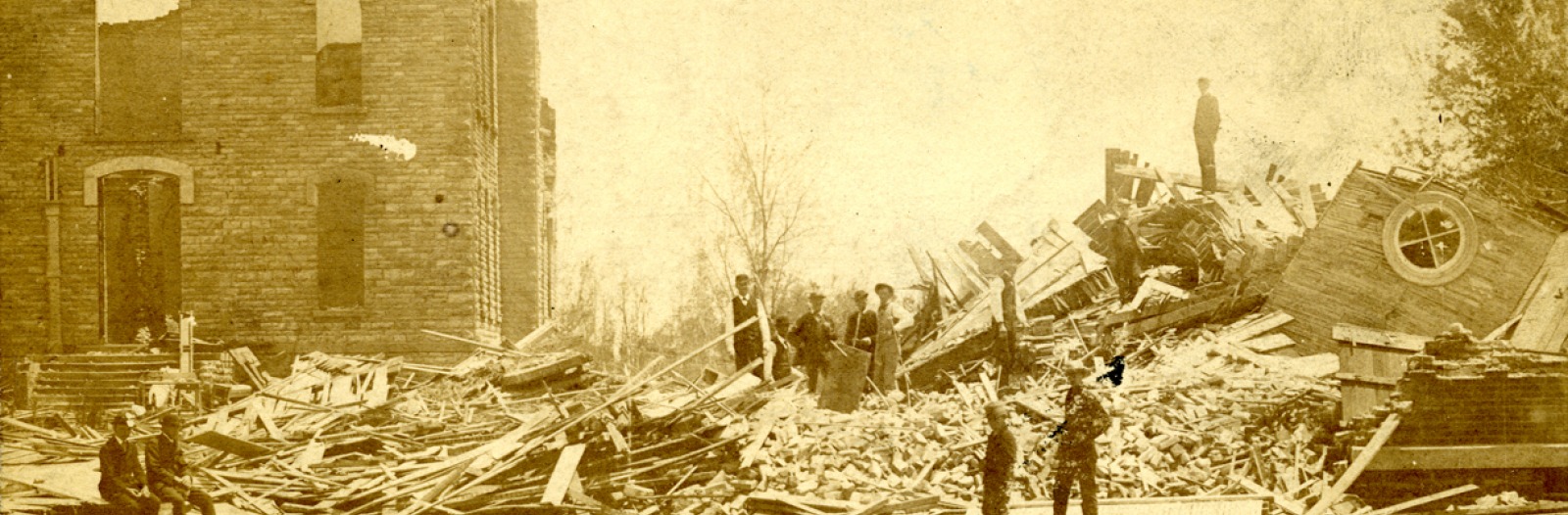 Two men survey destroyed buildings