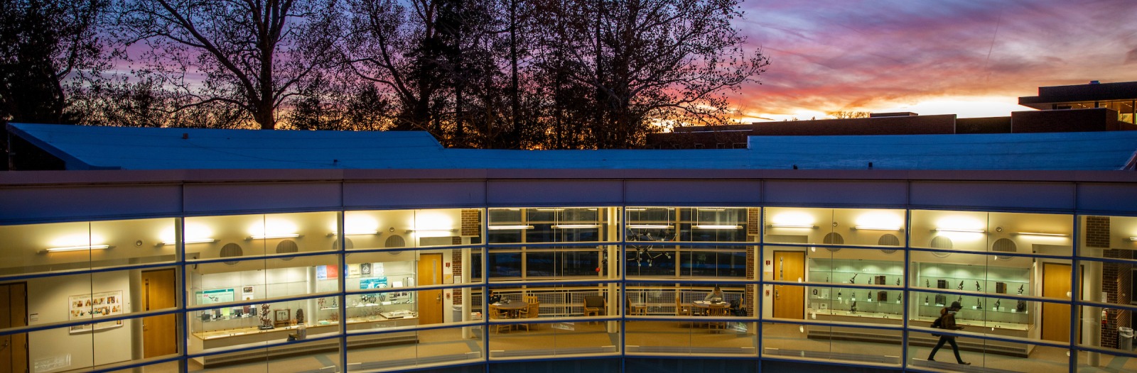 Sunset over the Noyce Science Center's "Elbow" where students are seen studying through a wall of windows