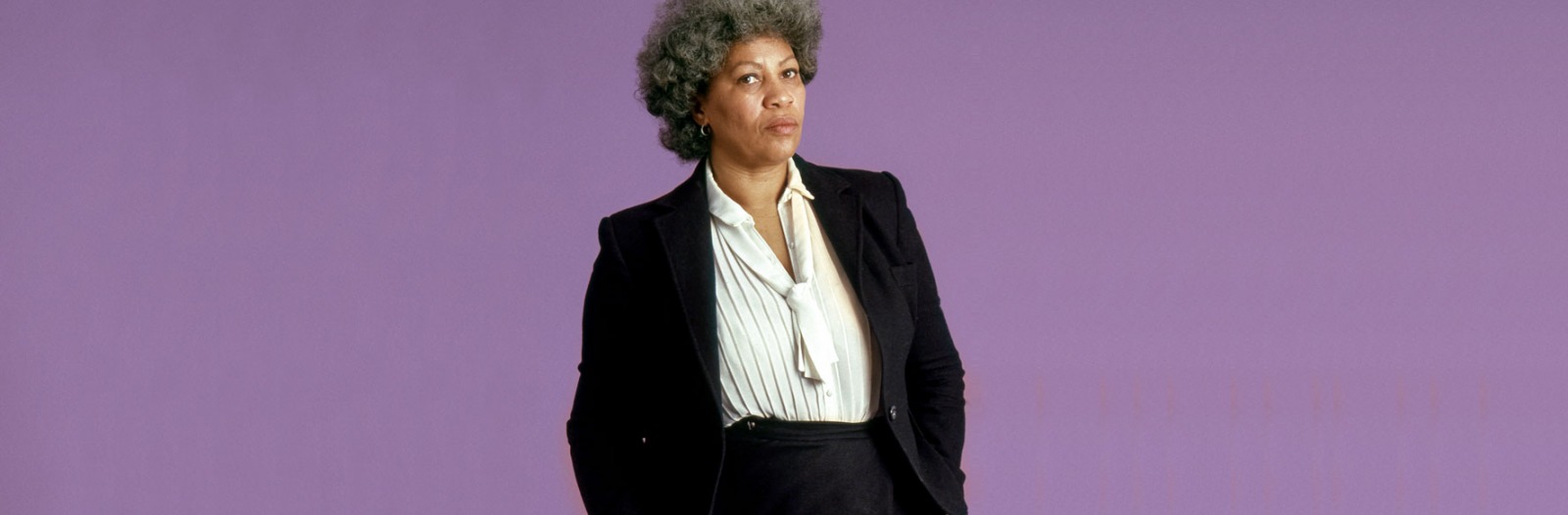 Toni Morrison in suit with purple background