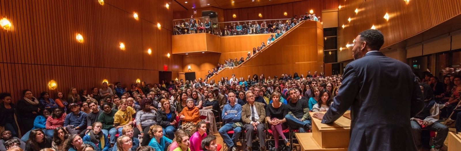 Speaker in Rosenfield Center, Room 101 presents to a crowd.