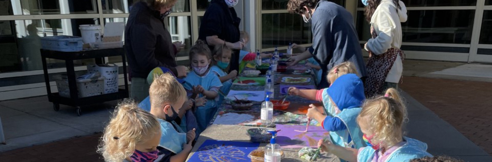 View of children painting at a long table