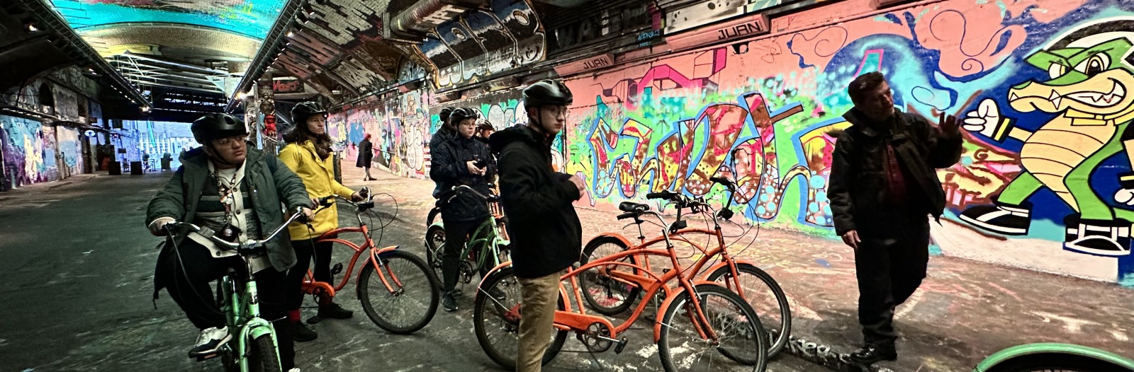 GIL students on cycling route around London in street art tunnel