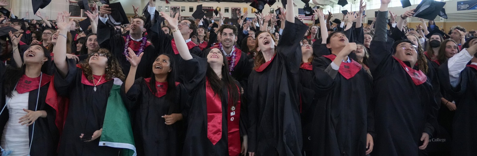 Graduates of the class of 2025 throw their caps in the air at commencement