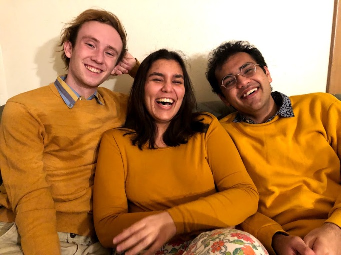 Conner and friends in photo wearing matching sweaters 