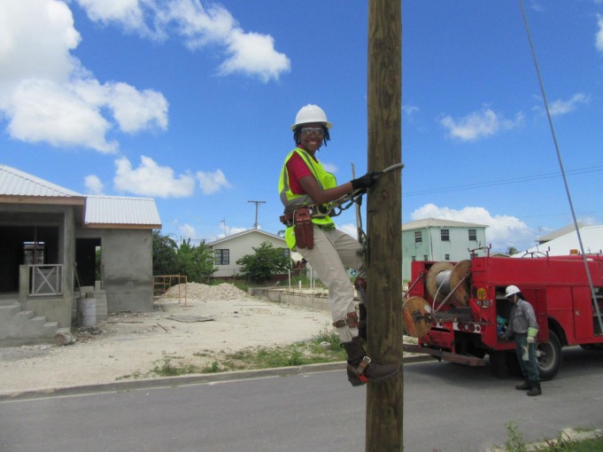 Engineer climbing up wood pylon 