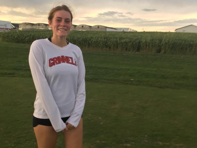 Girl standing in green field with grinnell shirt