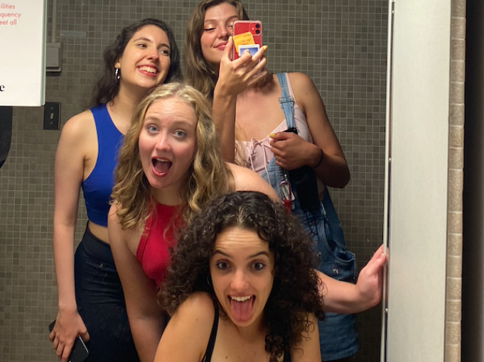 My four friends and I pose excitedly in front of a dorm bathroom mirror! We all have tank tops on for Harris party and we are ready to have fun haha.
