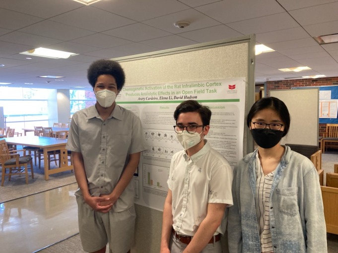 Me and my two science lab partners standing in front of our research presentation. We all have masks on because COVID