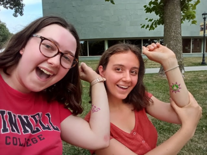 My friend Sasha and I pose together with matching arm tattoo stickers.