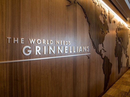 Wall in Admission and Student Financial Services room that says "The World Needs Grinnellians"