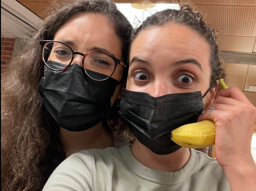 My friend and I excitedly take a selfie together. I'm holding up a banana across my ear as a phone, calling the universe during finals week.