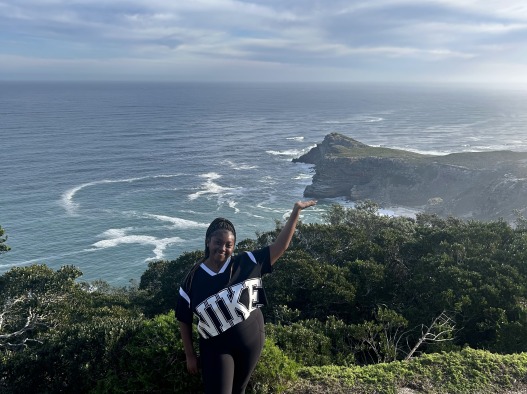 I put my hand up to the southern point of the South African land. I overlook the ocean.