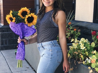Student holding Sunflowers