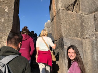 Camila Hassler preparing to follow group through a stone archway