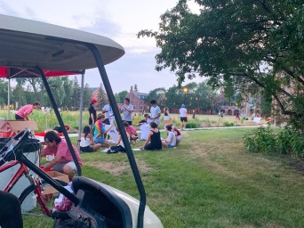 large gathering on north campus with golf cart in the foreground