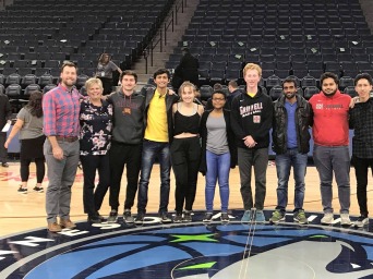 Group photo at center of basketball court